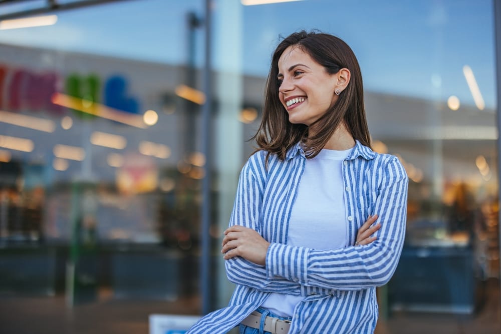 A smiling woman enjoying her radiant, whitened smile after professional teeth whitening, reflecting improved confidence and cosmetic dental care in Orlando – Teeth Whitening Orlando.