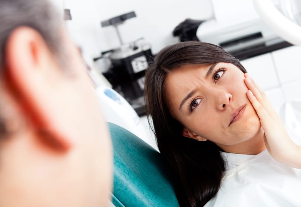 woman experiencing tooth ache - Root Canal Kissimmee