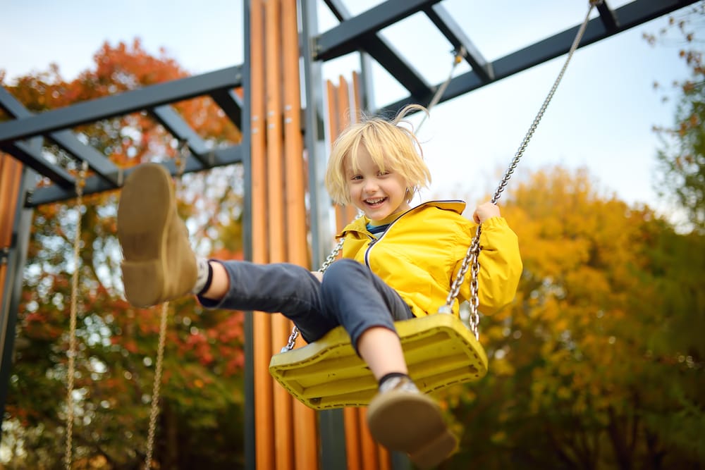 boy playing at the swing