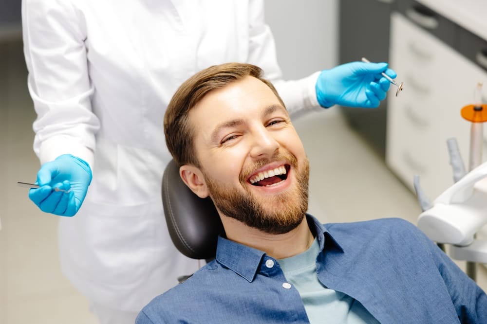 smiling bearded man at the dentist