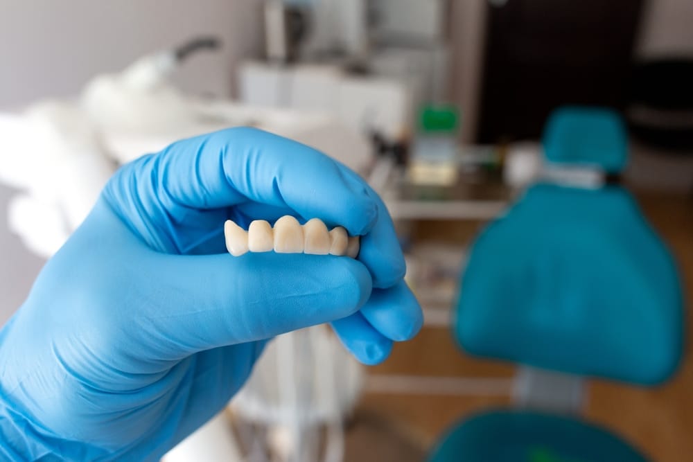 dentist holding dentures