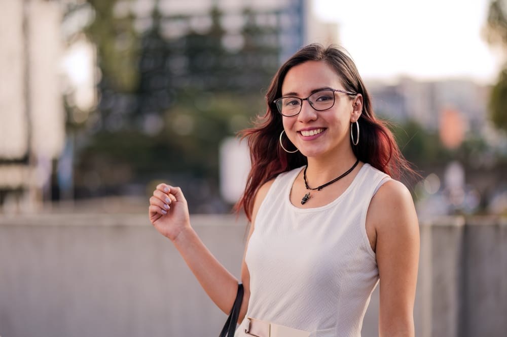 A professional woman posing for a photo outdoors - Dental Crowns Orlando