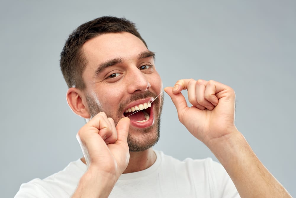 man flossing his teeth - Dentist in Orlando FL