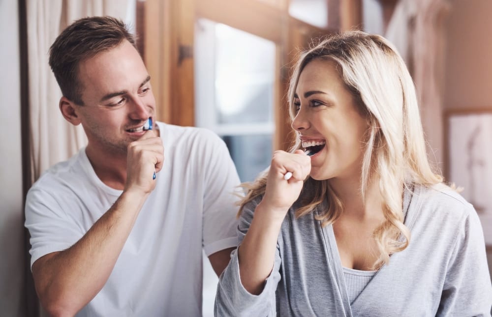 couple brushing their teeth - Dentist in Winter Park