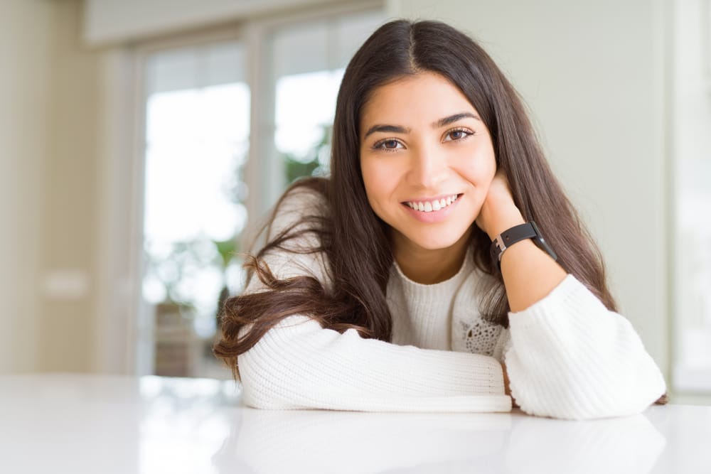 Woman wearing a sweater at home - Root Canal Kissimmee
